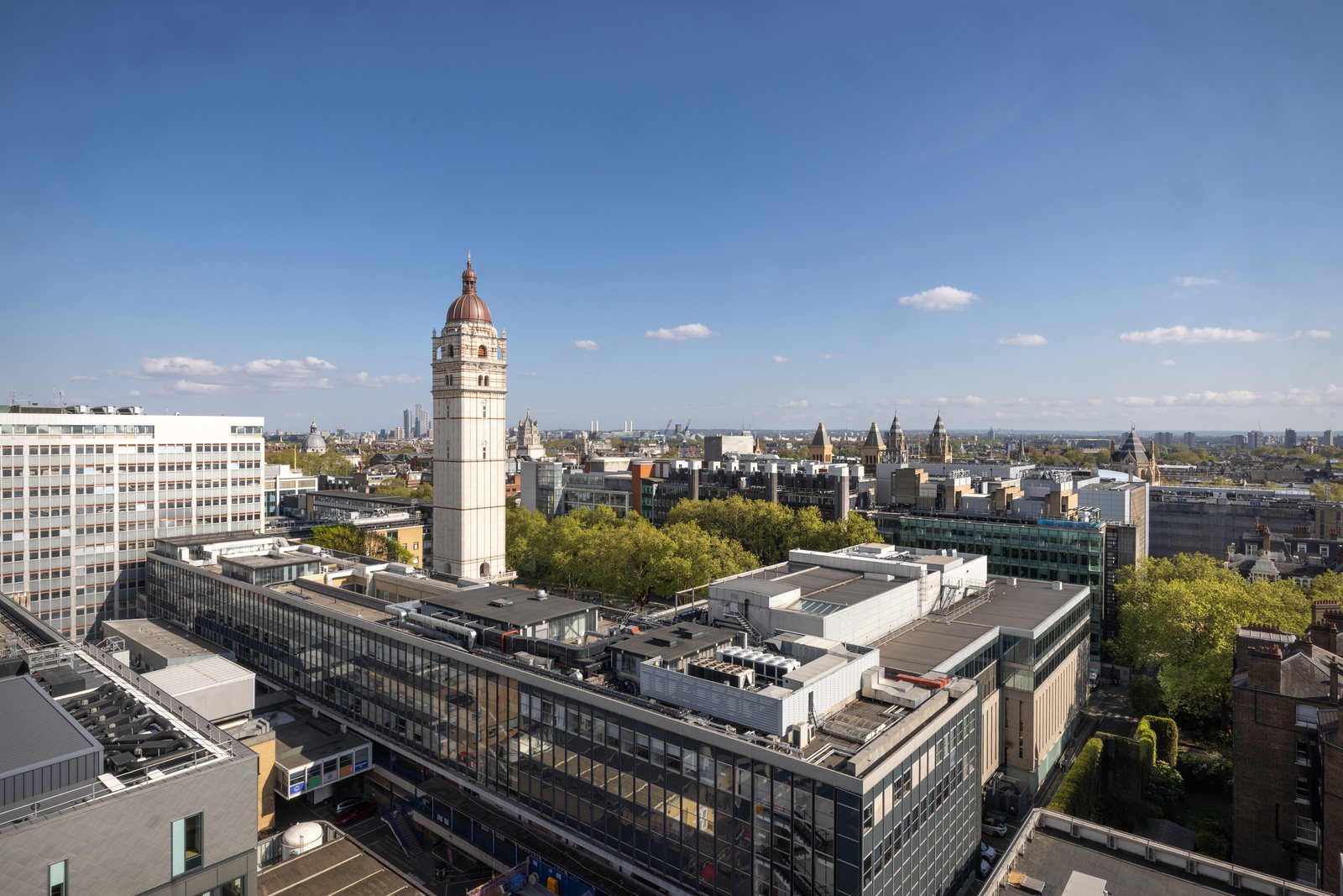 Queen's Tower at Imperial College London on a clear day, the South Kensington rooftops and the London skyline stretching behind it