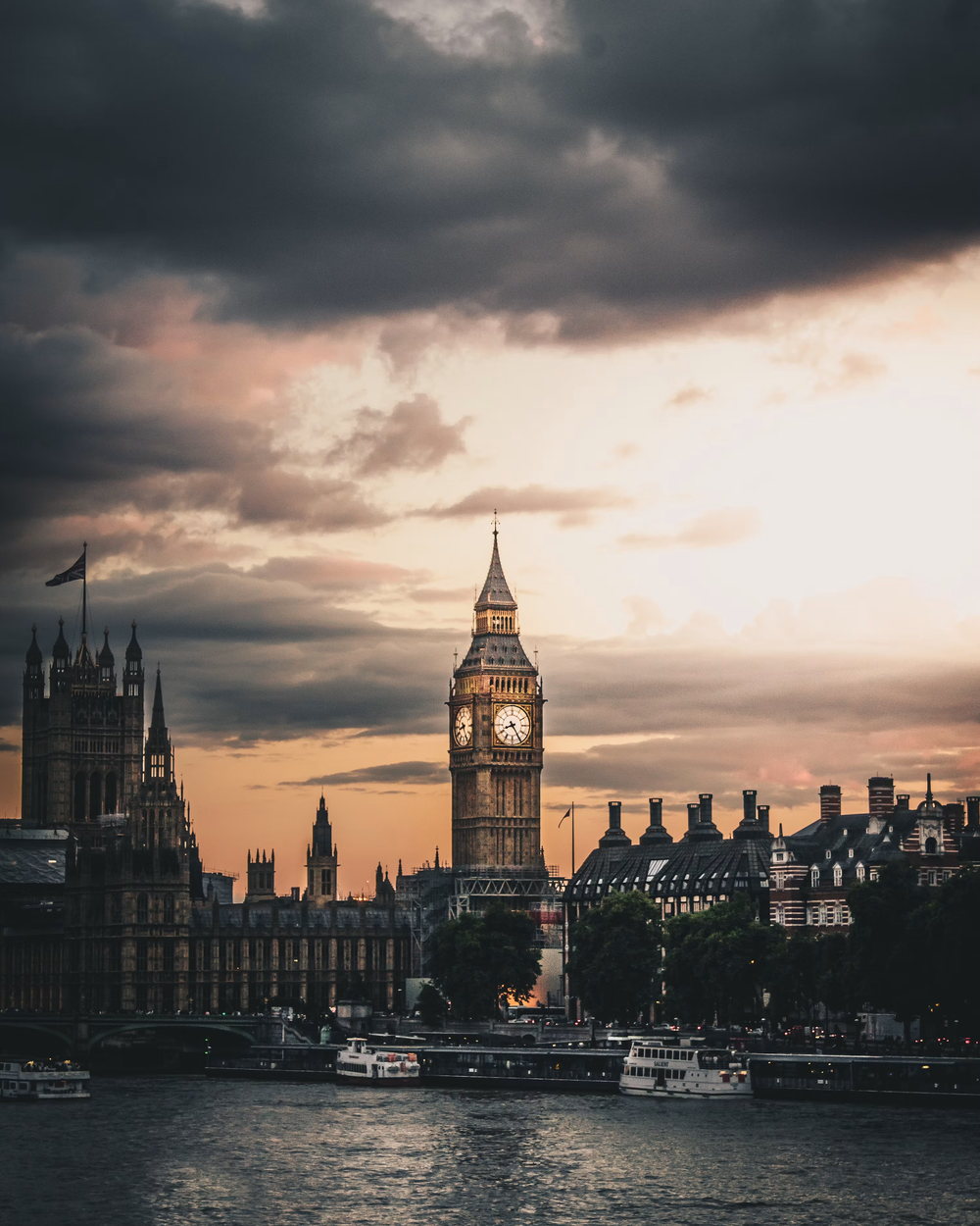 Westminster and the Palace of Westminster clock tower at dusk, seen across the Thames